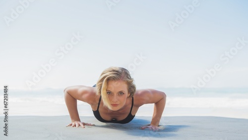 Fit blonde in plank position on the beach © WavebreakmediaMicro