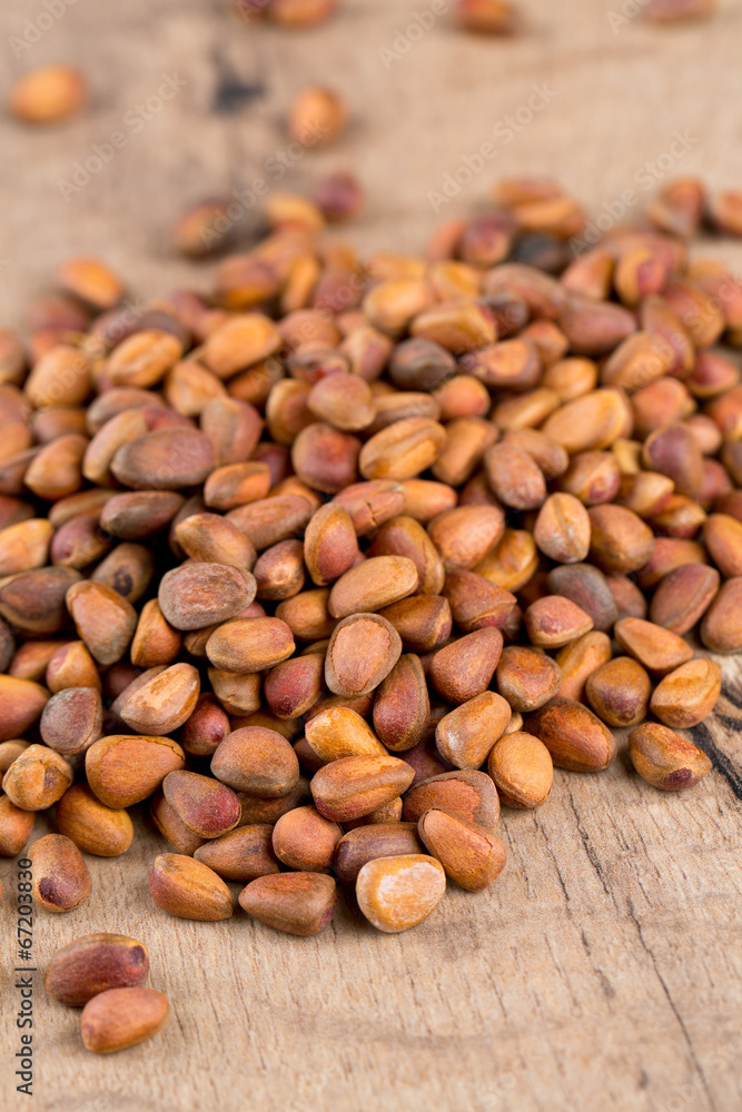 pine nuts on wooden surface pine nuts on wooden surface