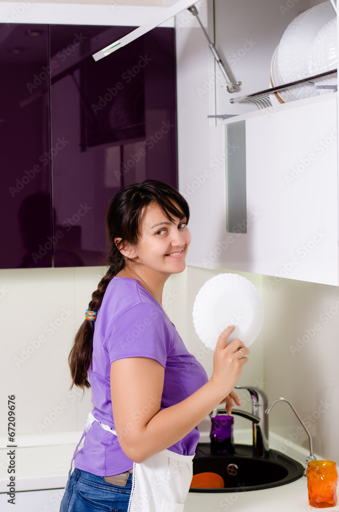 Attractive housewife doing the dishes Attractive housewife doing the dishes