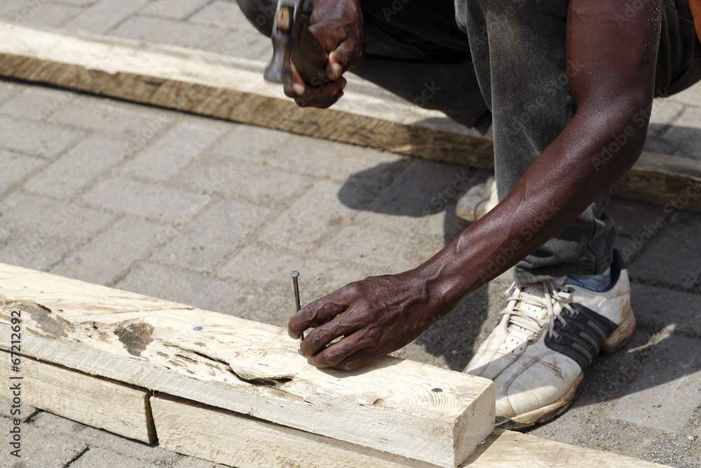 African carpenter works with wood