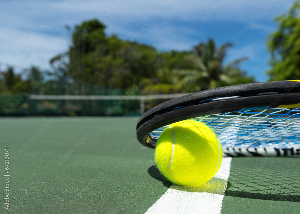 view of tennis racket and balls on the clay tennis court