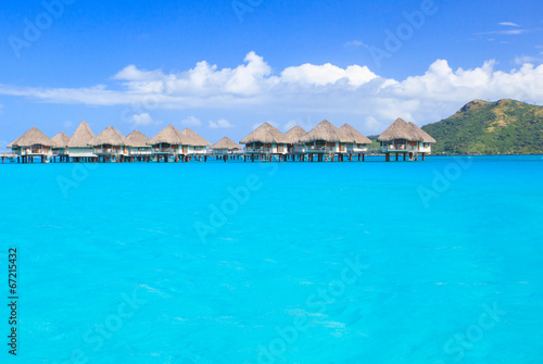 Overwater villas in blue tropical lagoon, Bora Bora, French Polynesia, South Pacific  © Juancat