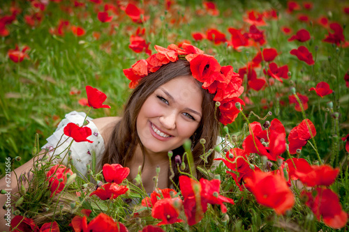 beautiful woman sitting in the poppy flower