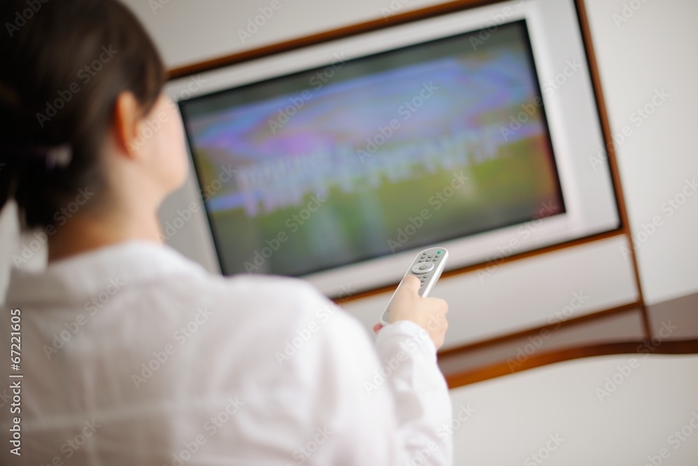young woman watching tv at home young woman watching tv at home