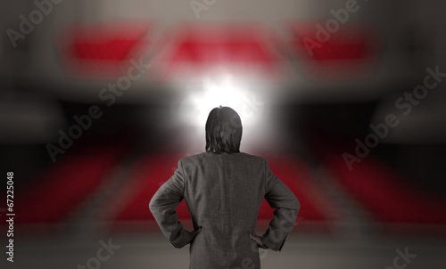 Фотография businessman in front of a podium and an audience as concept