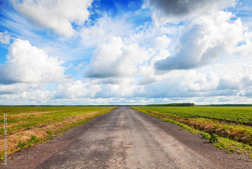 Empty country road perspective with dramatic cloudy sky Empty country road perspective with dramatic cloudy sky