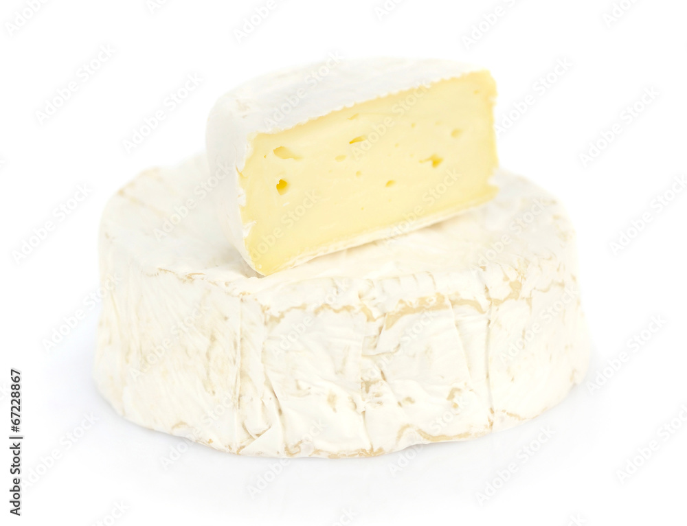Round camembert cheese with a piece on white background