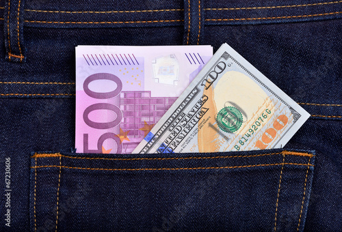 Dollar and euro banknotes in jeans pocket