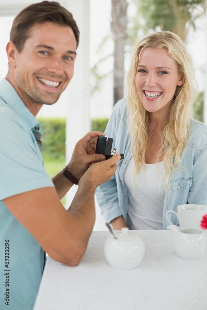 Man proposing marriage to his shocked blonde girlfriend Man proposing marriage to his shocked blonde girlfriend