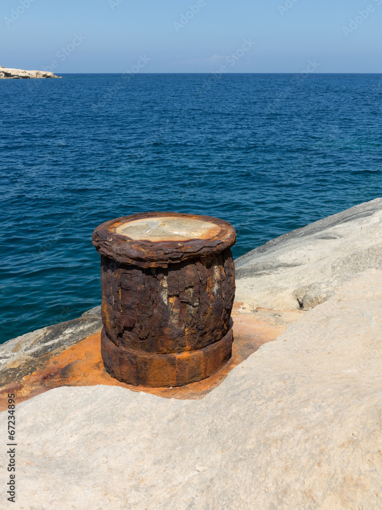 Naklejka premium Rusty old iron column on the coast of Valletta, Malta
