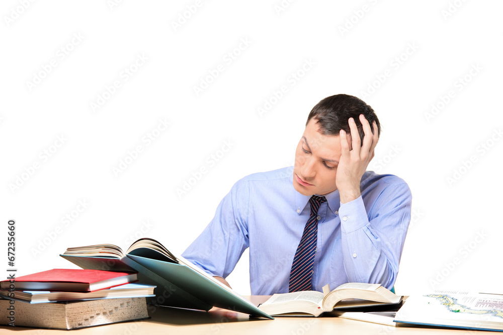 Young man studying some problem seated at a table Young man studying some problem seated at a table