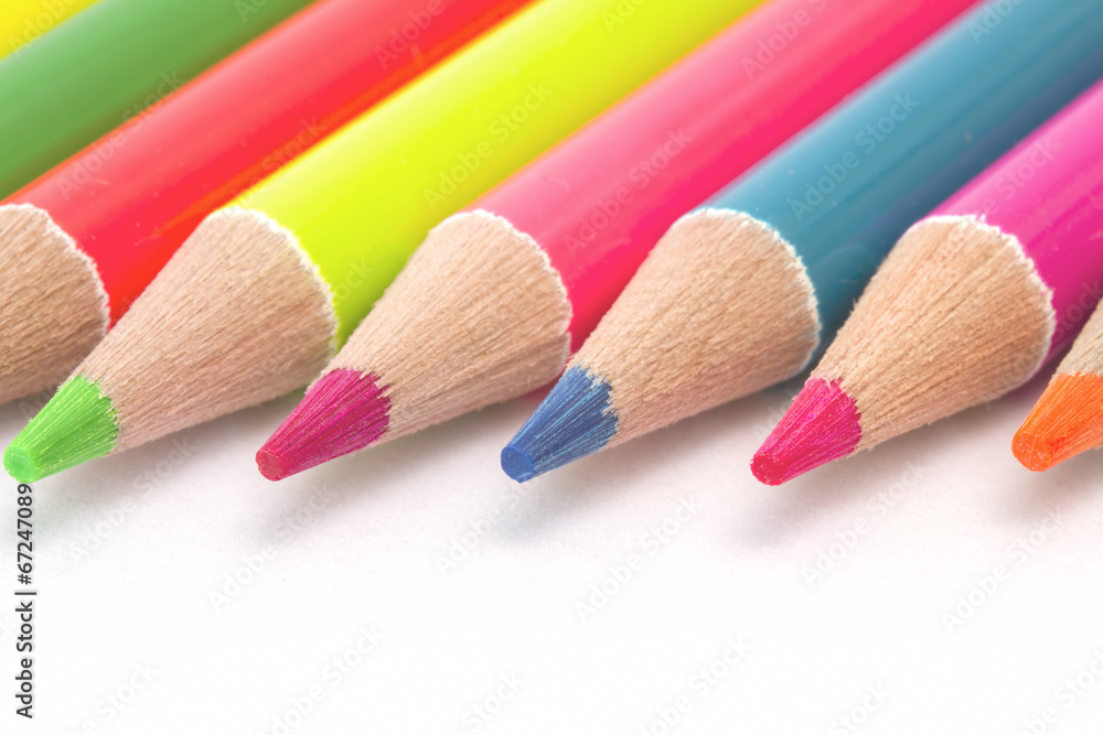 Close up bright color pencils on white paper Close up bright color pencils on white paper