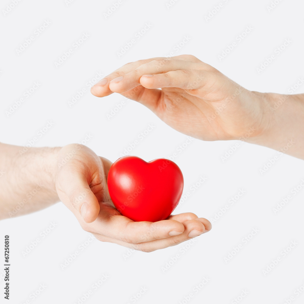 male hands with small red heart