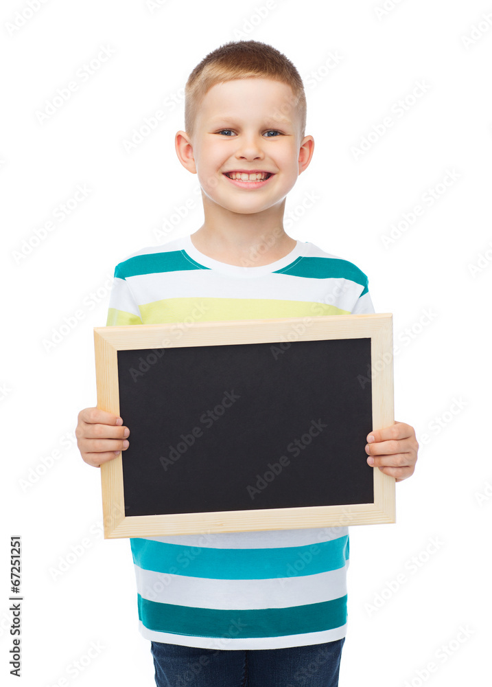 smiling little boy holding blank black chalkboard smiling little boy holding blank black chalkboard