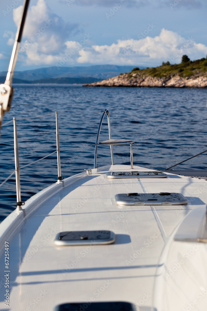 Fototapeta premium The white yacht floats by the blue sea