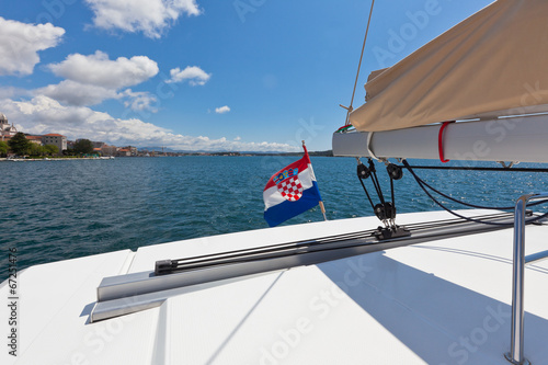 The white yacht floats by the blue sea in Croatia