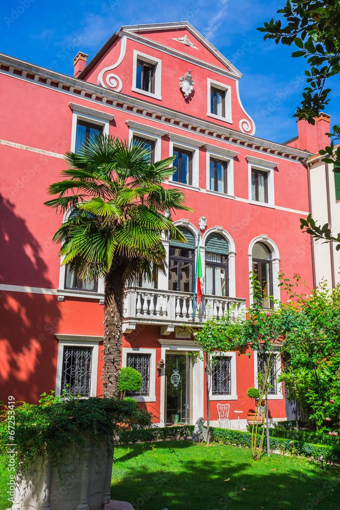 Naklejka premium Narrow canal among old colorful brick houses in Venice