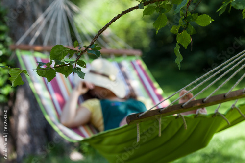 Woman sleeping on a hammock photo