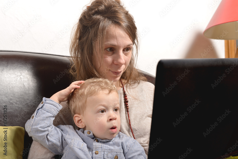 young mother and her child looking at a laptop young mother and her child looking at a laptop