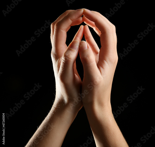 Slika na platnu Human hands on black background
