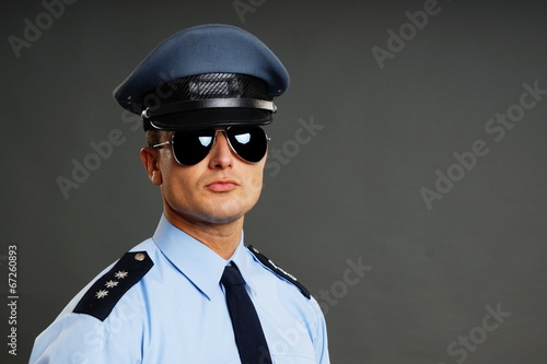 Portrait of policeman in uniform in sunglasses