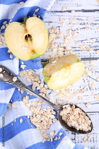 Apple with oatmeal and vintage spoons