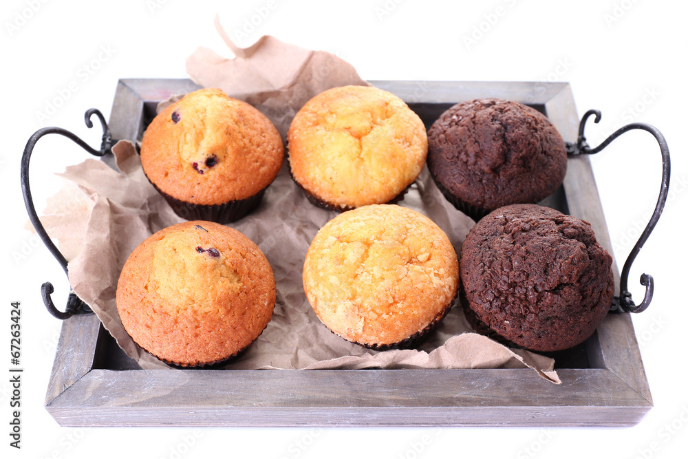 Tasty muffins on wooden tray isolated on white Tasty muffins on wooden tray isolated on white