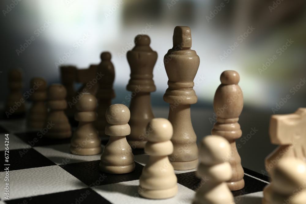 Chess board with chess pieces on dark background Chess board with chess pieces on dark background