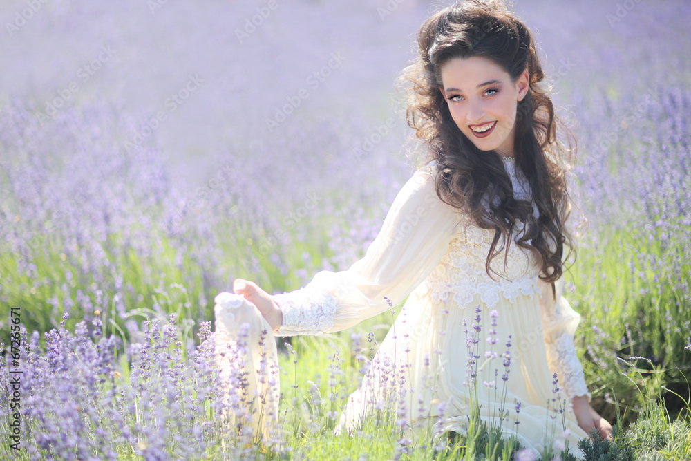 Pretty Young Girl Outdoors in a Lavender Flower Field Pretty Young Girl Outdoors in a Lavender Flower Field