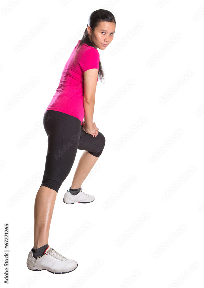 Female Asian in sports attire doing stretching exercise Stock Photo