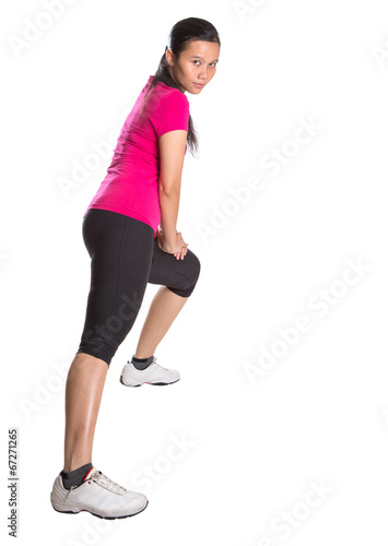 Female Asian in sports attire doing stretching exercise