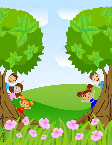 children peek out from trees