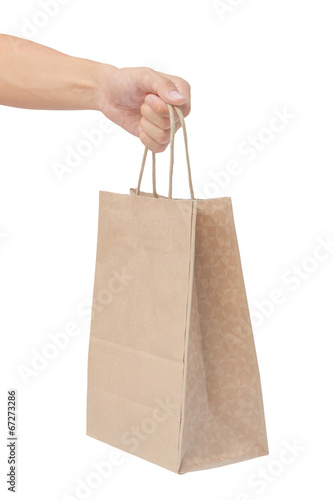 Hand holding and giving paper bag isolated over white background