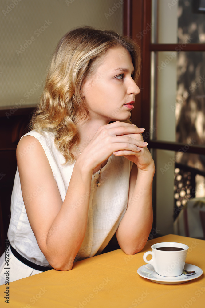 Girl in cafe with cup of coffee Girl in cafe with cup of coffee