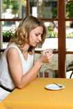 Girl in cafe drinking coffee