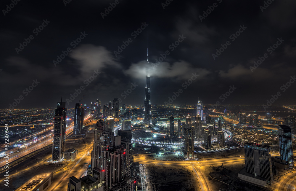 Fototapeta premium Scattered clouds passing by Burj khalifa and the downtown Dubai