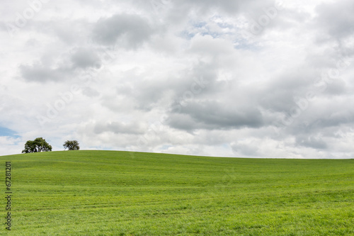 Dark clouds over a grass hill (left)