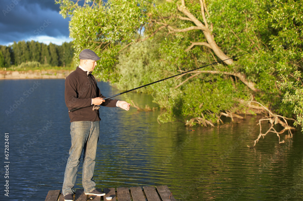 man fishing in a pond man fishing in a pond