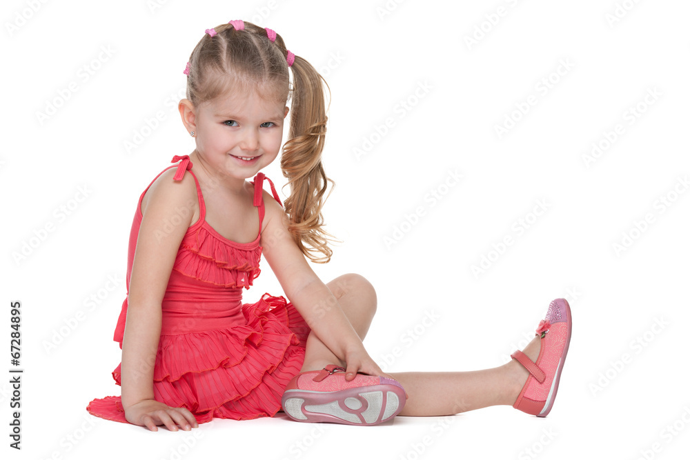 Happy little girl sits on the floor Happy little girl sits on the floor