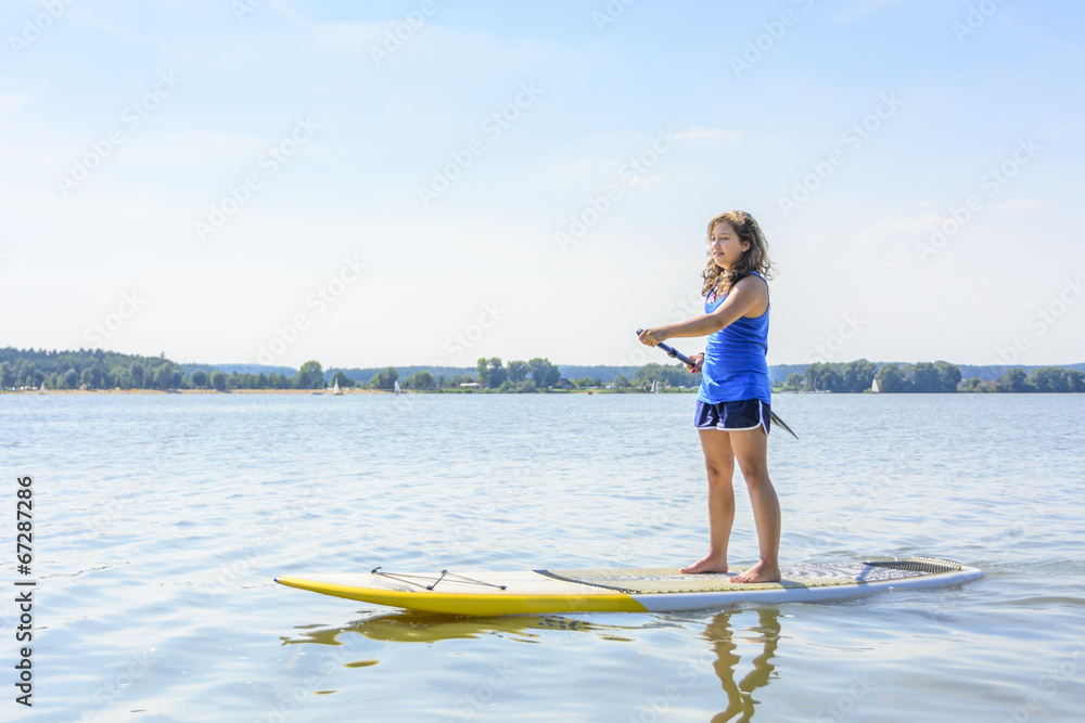 Teenager beim SUP Stock Photo | Adobe Stock
