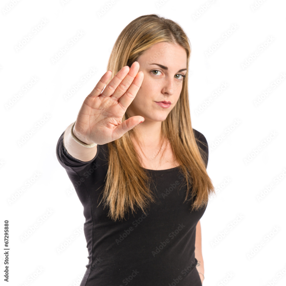 Blonde girl making stop sign over white background Blonde girl making stop sign over white background