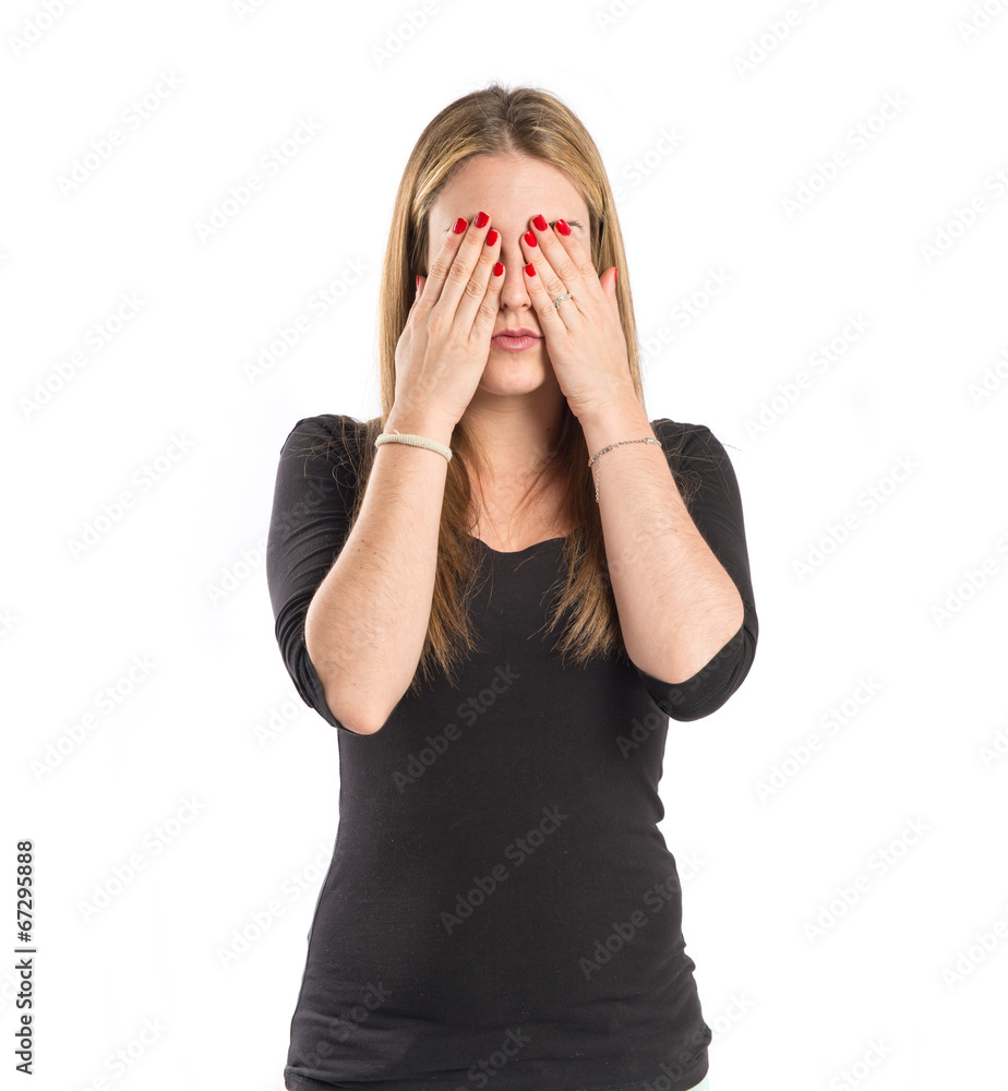 Blonde girl covering her eyes over isolated white background Blonde girl covering her eyes over isolated white background