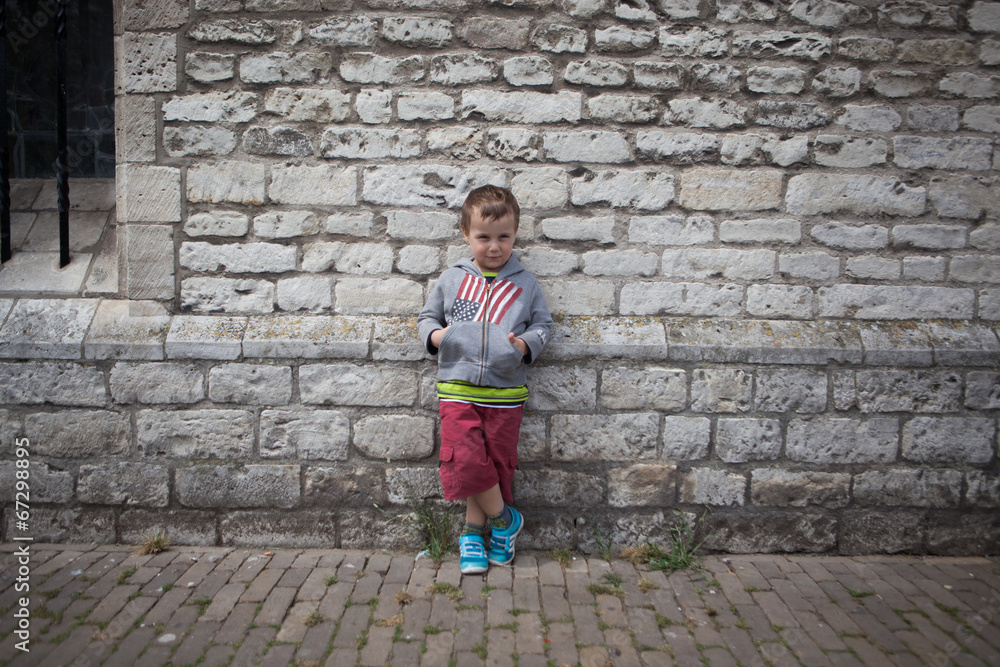 cute boy in front of wall cute boy in front of wall