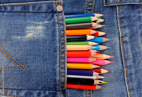 set of multicolored pencils in blue jeans pocket