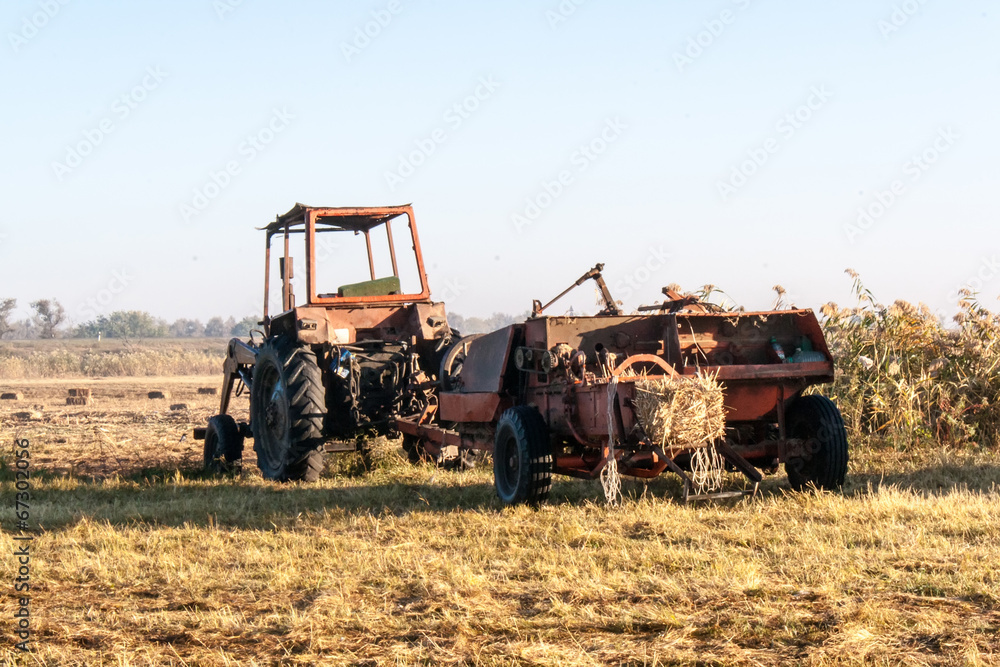 Fototapeta premium Old tractor standing on the field
