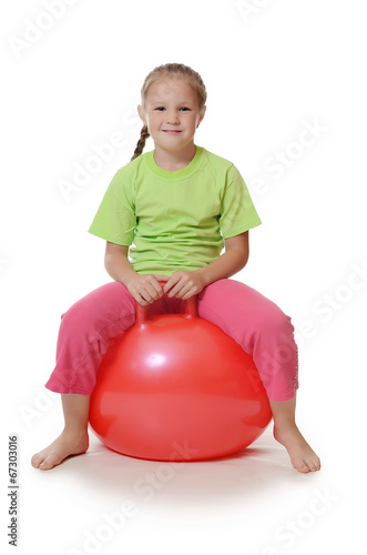 Little girl on a gymnastic ball