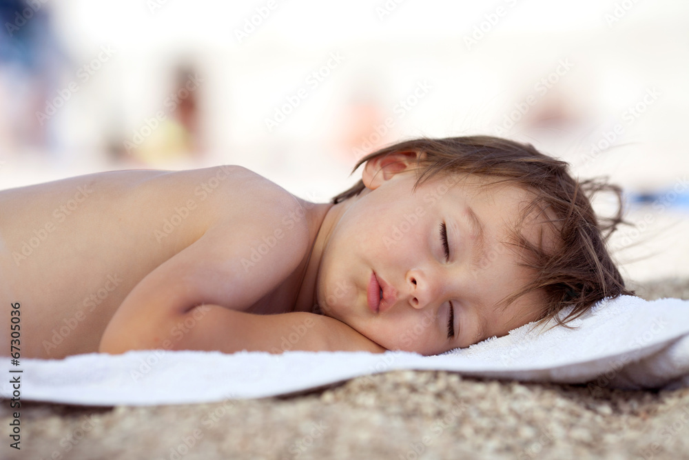Adorable baby boy, sleeping on the beach Adorable baby boy, sleeping on the beach