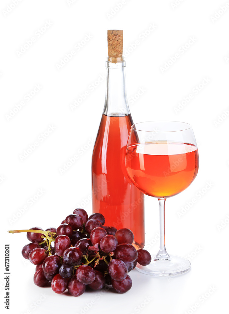 Ripe grapes, wine glass and bottle of wine isolated on white