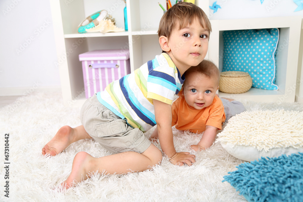 Cute little boys on floor in room Cute little boys on floor in room