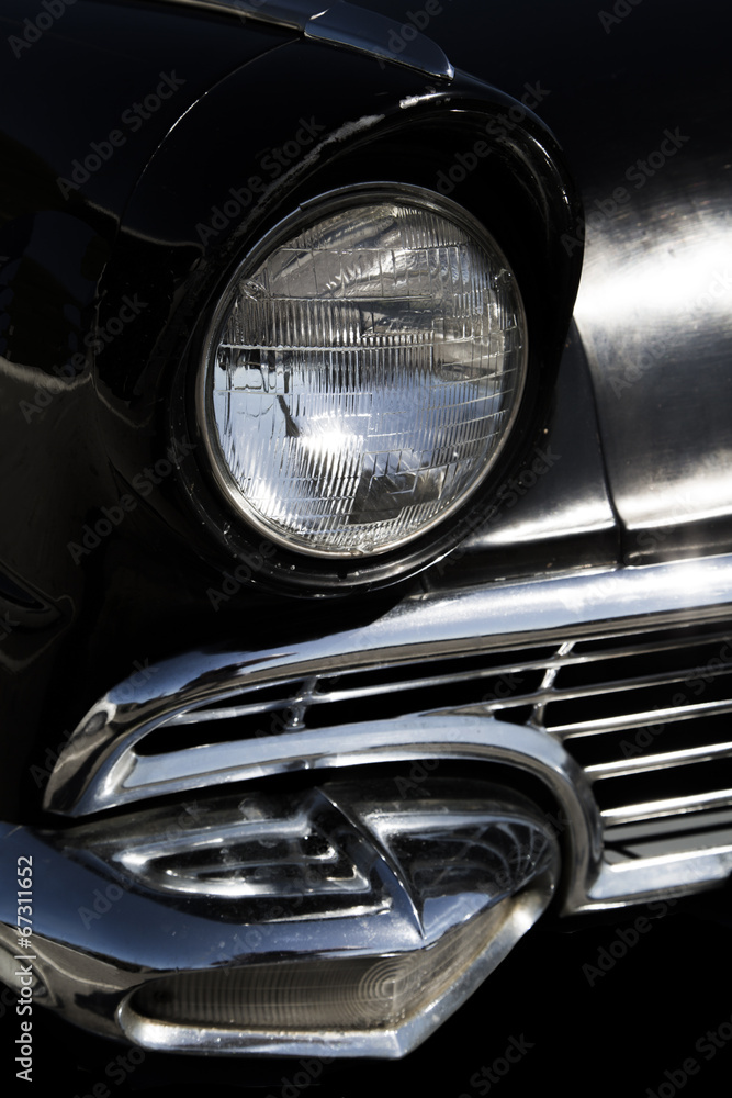 Classic sixties black car front headlight and grill
